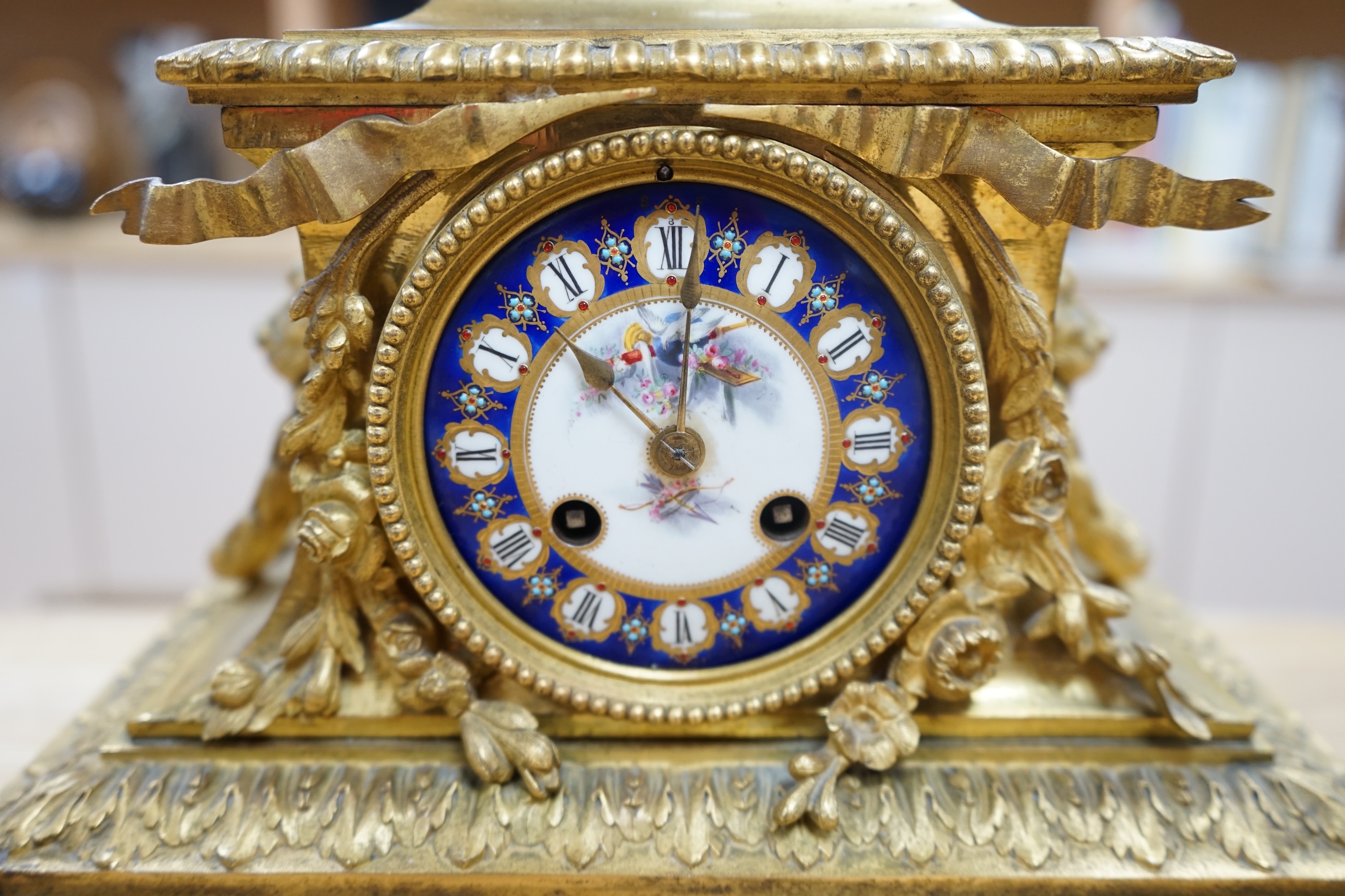 A 19th century Sevres style jewelled porcelain and ormolu matched clock garniture, striking on a bell, with pendulum, 51cm high. Condition - fair to good, minor restoration, untested